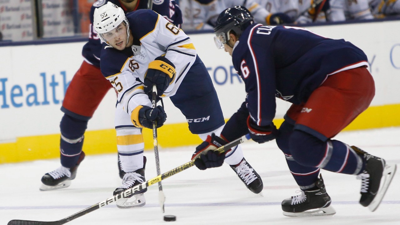 Buffalo Sabres' Danny O'Regan, left, of Germany, passes the puck as Columbus Blue Jackets' Adam Clendening defends during the third period of a preseason NHL hockey game Monday, Sept. 17, 2018, in Columbus, Ohio. (Jay LaPrete/AP)