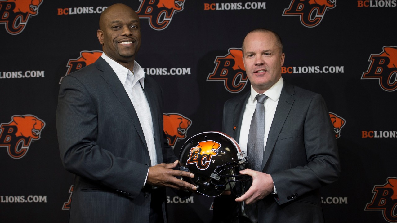 BC Lions general manager Ed Hervey, left, is stepping down after three years. (Jonathan Hayward/CP)