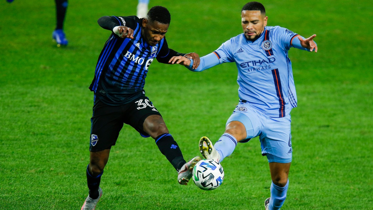 New York City FC defender Alexander Callens, right, and Montreal Impact attacker Romell Quioto battle for the ball during an MLS soccer match. (Eduardo Munoz Alvarez/AP)