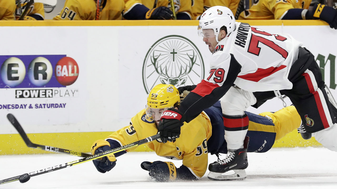Ottawa Senators right wing Jayce Hawryluk (79) and Nashville Predators defenseman Roman Josi (59), of Switzerland, battle for the puck. (Mark Humphrey/AP)