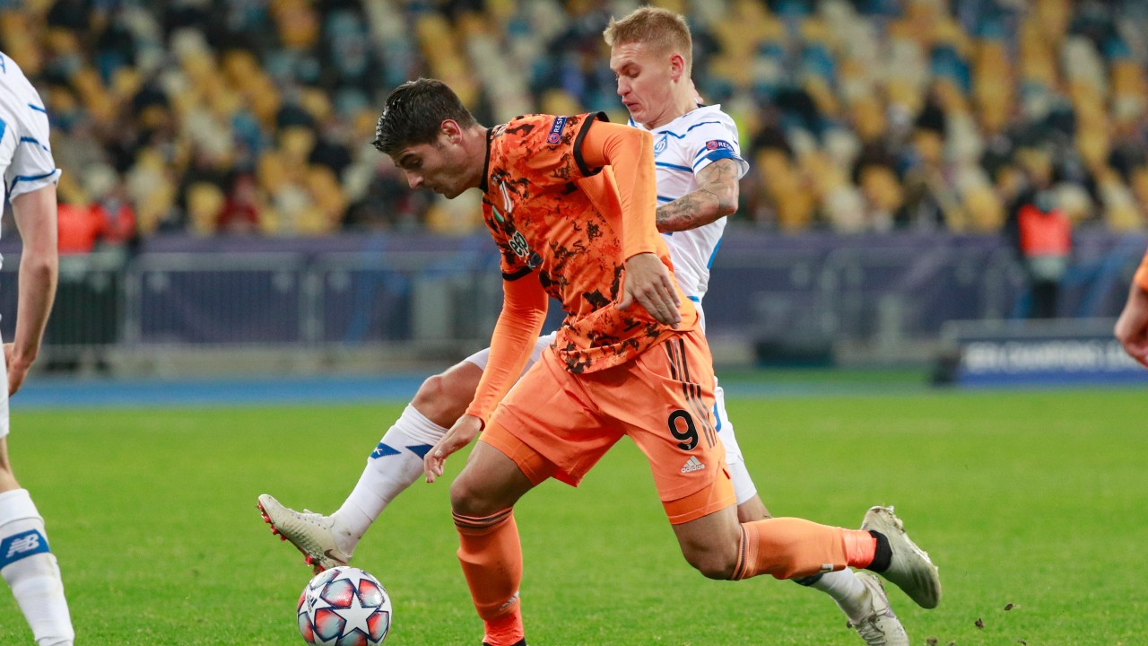 Juventus' Alvaro Morata. left, challenges for the ball with Dynamo Kyiv's Vitaliy Buyalskyi during the Champions League, group G, soccer match between Dynamo Kyiv and Juventus. (Valentyn Ogirenko/Pool via AP)