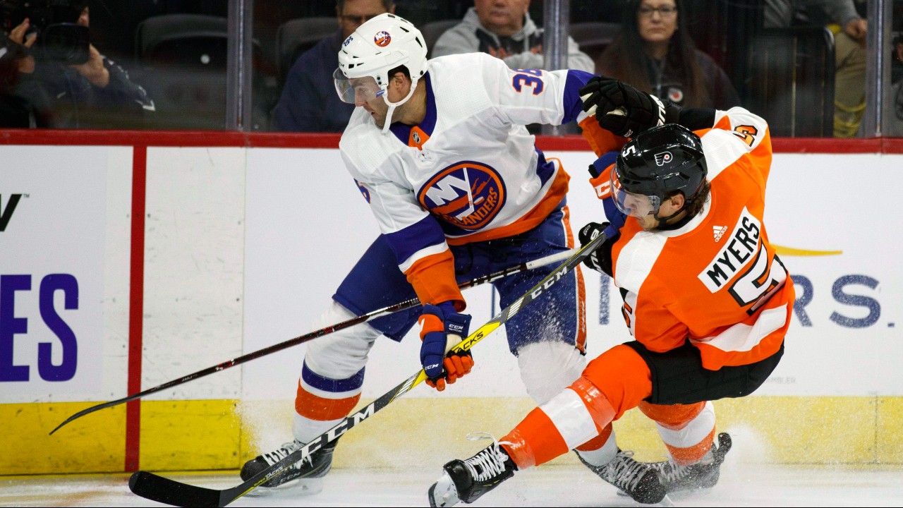 Philadelphia Flyers' Philippe Myers (5) and New York Islanders' Kyle Burroughs (38) battle for the puck during the first period of a preseason NHL hockey game. (Matt Slocum/AP)