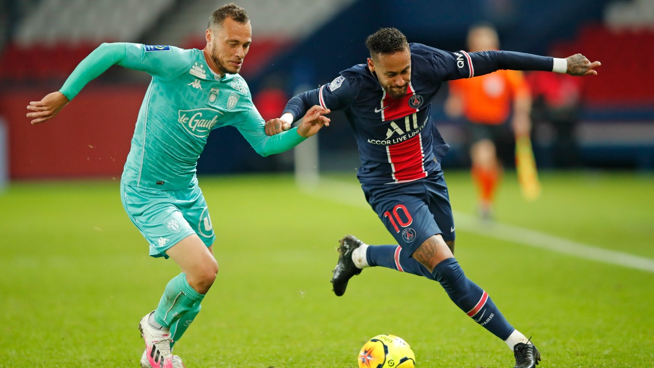 PSG's Neymar, right, takes on Angers' Vincent Manceau during the French League One soccer match between Paris Saint-Germain and Angers. (Francois Mori/AP)