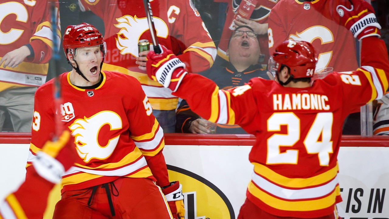 Calgary Flames' Buddy Robinson, left, celebrates his goal with teammate Travis Hamonic during first period NHL hockey action against the Edmonton Oilers. (Jeff McIntosh/CP)