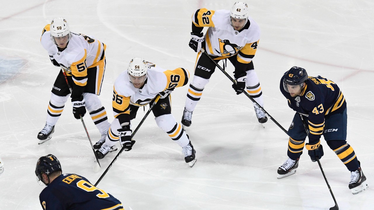 Pittsburgh Penguins' Jusso Riikola (50), Ryan Haggerty (56), Sam Miletic (42) and Buffalo Sabres' Conor Sheary (43) wait for a face off during an NHL preseason hockey game Monday, Sept. 16, 2019, in State College, Pa. (John Beale / AP)