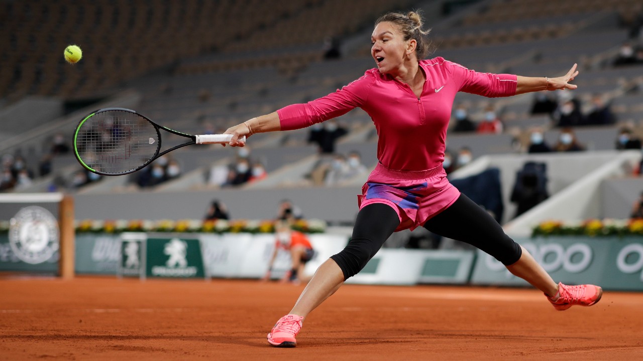 Simona Halep plays a shot against Iga Swiatek in a fourth round match at the French Open. (Alessandra Tarantino/AP)