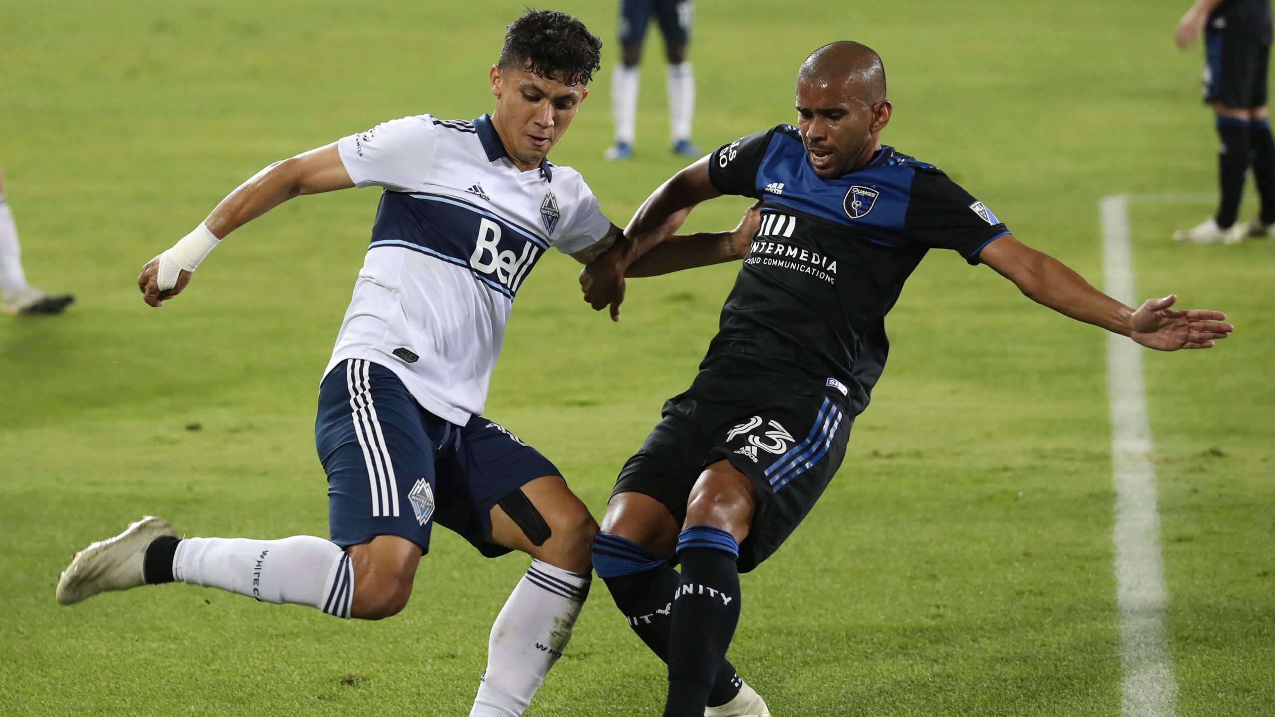 Vancouver Whitecaps forward Fredy Montero, left, and San Jose Earthquakes midfielder Judson (93) go for the ball during the first half of an MLS soccer match. (Josie Lepe/AP)