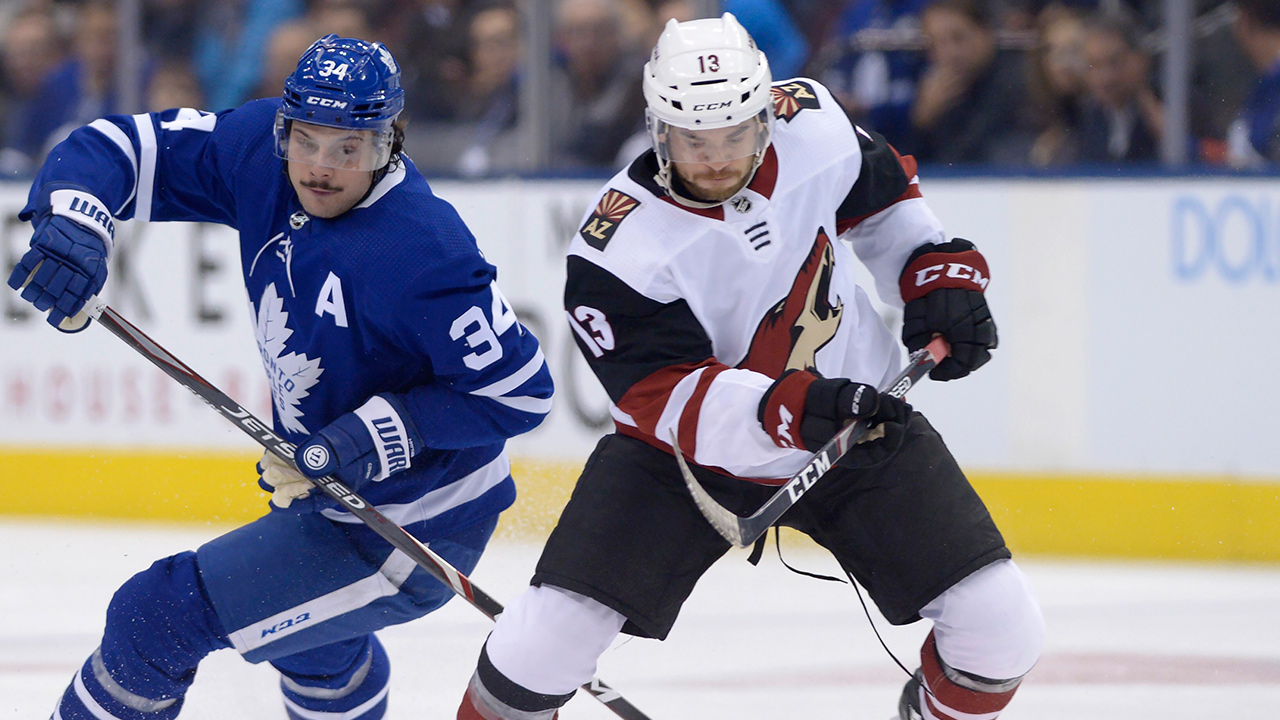 Toronto Maple Leafs centre Auston Matthews (34) and Arizona Coyotes right wing Vinnie Hinostroza (13) battle for the puck during first period action in Toronto on Tuesday Feb. 11, 2020. (Nathan Denette/CP)