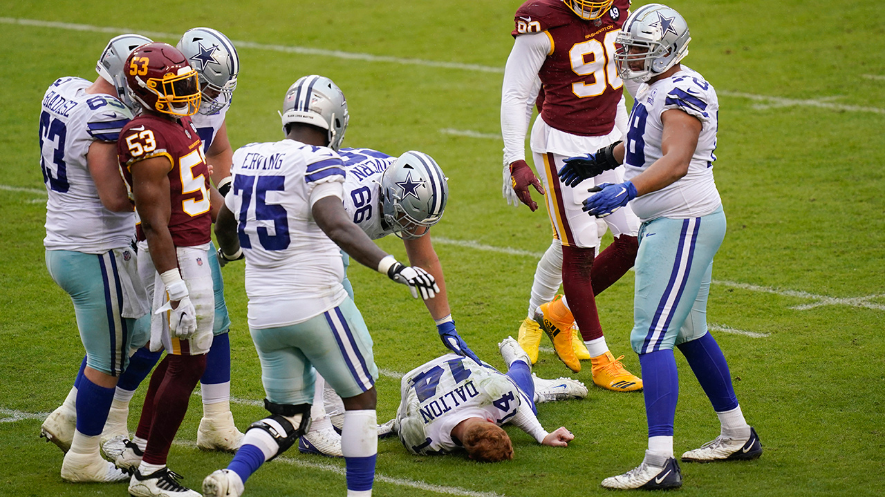 Dallas Cowboys quarterback Andy Dalton (14) lies on the ground after getting hit by Washington Football Team inside linebacker Jon Bostic (53) in the second half of an NFL football game, Sunday, Oct. 25, 2020, in Landover, Md. (Patrick Semansky/AP)
