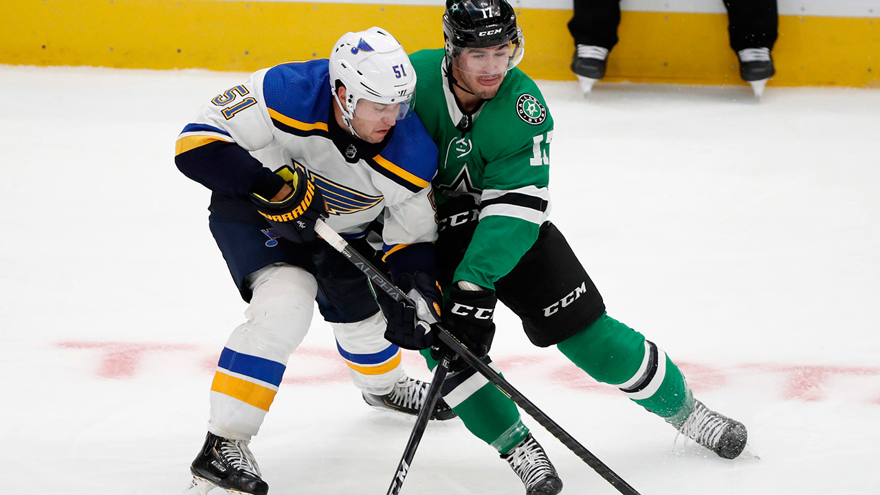 St. Louis Blues defenceman Derrick Pouliot (51) and Dallas Stars right wing Nicholas Caamano (17) compete for control of the puck in the third period of a pre-season game in Dallas, Monday, Sept. 16, 2019. (Tony Gutierrez/AP)