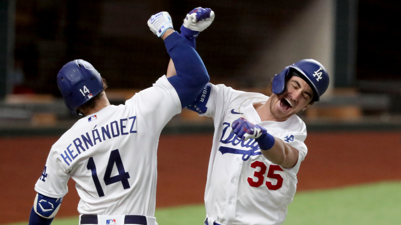 Los Angeles Dodgers' Cody Bellinger, right, celebrates his solo home run with Enrique Hernandez against Atlanta Braves relief pitcher Chris Martin during the seventh inning in Game 7 of a baseball National League Championship Series, Sunday, Oct. 18, 2020, in Arlington, Texas. (Curtis Compton/Atlanta Journal-Constitution via AP)
