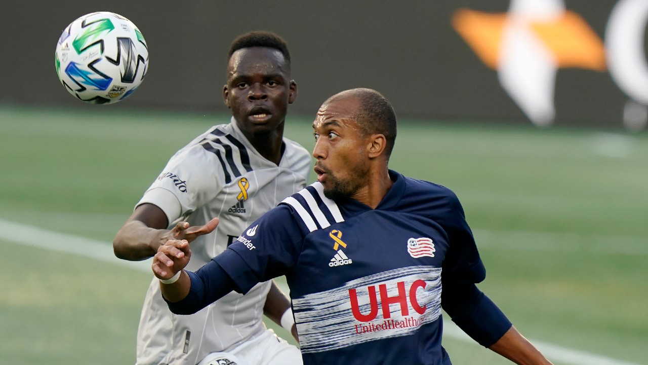 Montreal Impact's Karifa Yao, left, and New England Revolution's Teal Bunbury, right, keep their eyes on the ball during the first half of an MLS soccer match, Wednesday, Sept. 23, 2020, in Foxborough, Mass. (Steven Senne/AP)