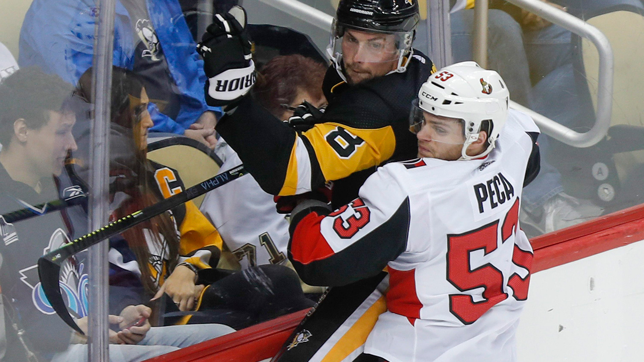 Ottawa Senators' Matthew Peca (53) checks Pittsburgh Penguins' Brian Dumoulin along the boards during the first period of an NHL hockey game, Tuesday, March 3, 2020, in Pittsburgh. (Keith Srakocic/AP)