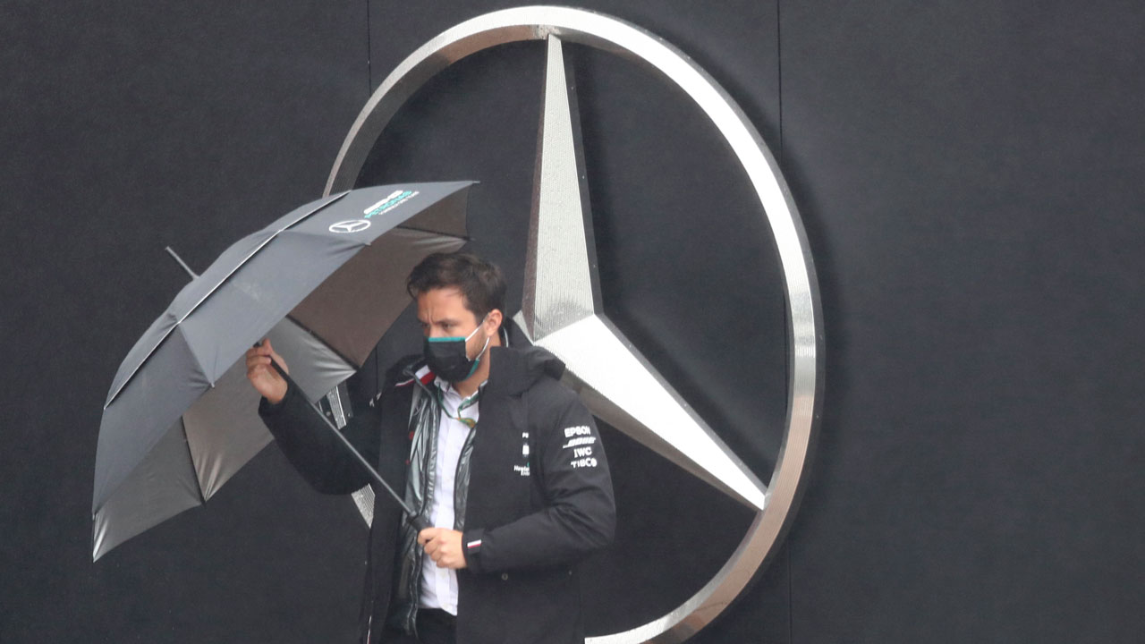Mercedes team principal Toto Wolff holds the umbrella ahead of the second practice session for the Eifel Formula One Grand Prix at the Nuerburgring racetrack. (Matthias Schrader/AP)