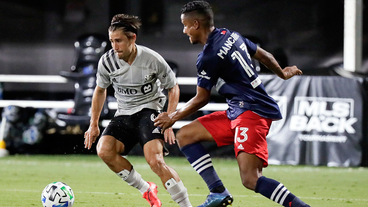 Montreal Impact's Bojan, left, makes a move to get past New England Revolution's Michael Mancienne (13) during the second half of an MLS match Thursday, July 9, 2020, in Kissimmee, Fla. (John Raoux/AP)