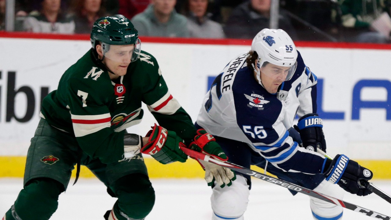Winnipeg Jets center Mark Scheifele (55) and Minnesota Wild Nico Sturm (7) battle for the puck in the second period of an NHL hockey game Saturday, Dec. 21, 2019, in St. Paul, Minn. (Andy Clayton-King/AP)