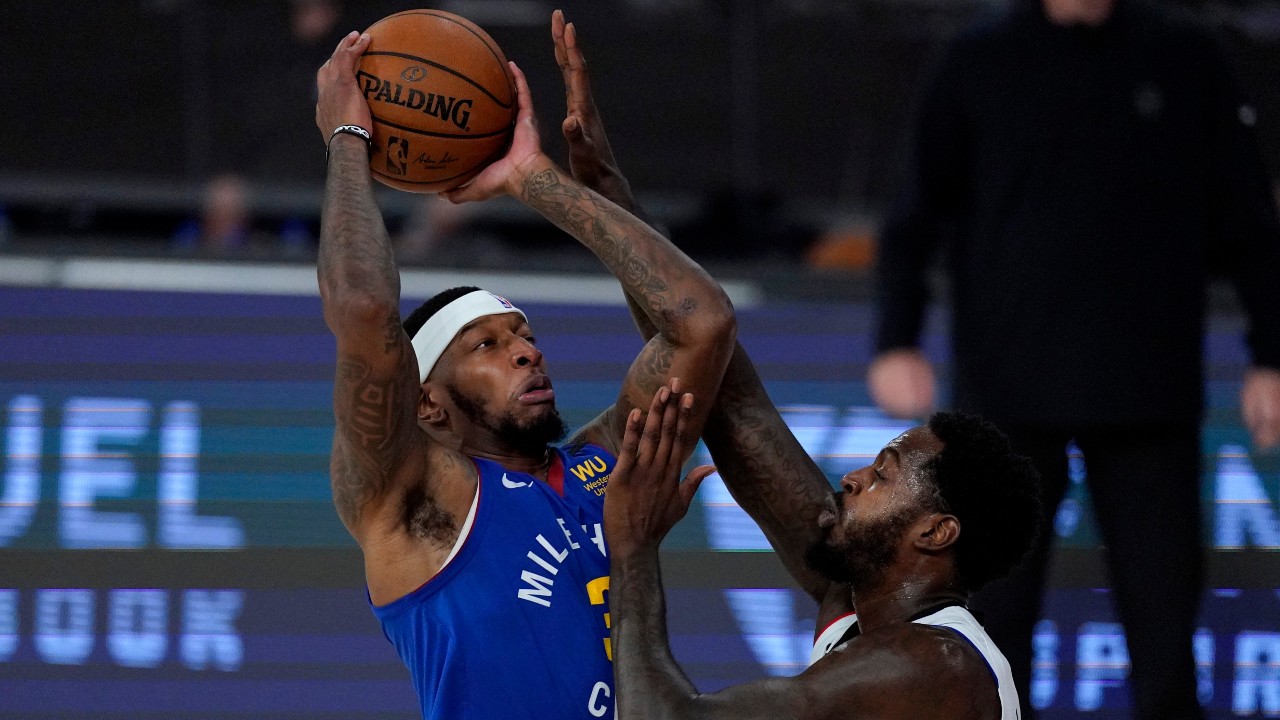 Denver Nuggets' Torrey Craig, left, goes up for a shot against Los Angeles Clippers' JaMychal Green during the first half of an NBA conference semifinal playoff basketball game. (Mark J. Terrill/AP)