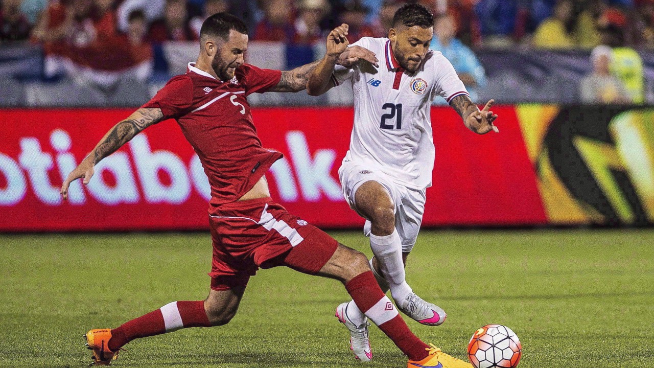 David Edgar (left) of Canada battles for the ball against David Ramirez of Costa Rica during the CONCACAF Gold Cup soccer action. (Aaron Vincent Elkaim/CP) 