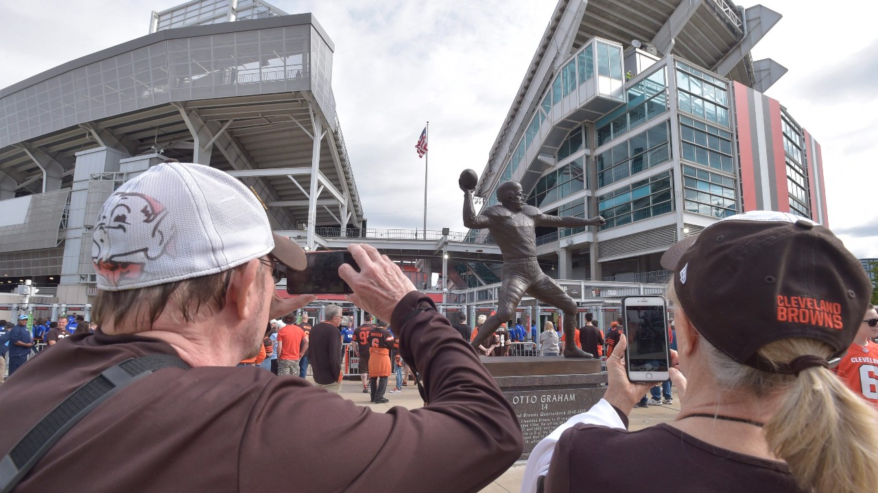 Cleveland Browns fans take a photo of the Otto Graham statue before an NFL football game between the Tennessee Titans and the Cleveland Browns, Sunday, Sept. 8, 2019, in Cleveland. (David Richard / AP)