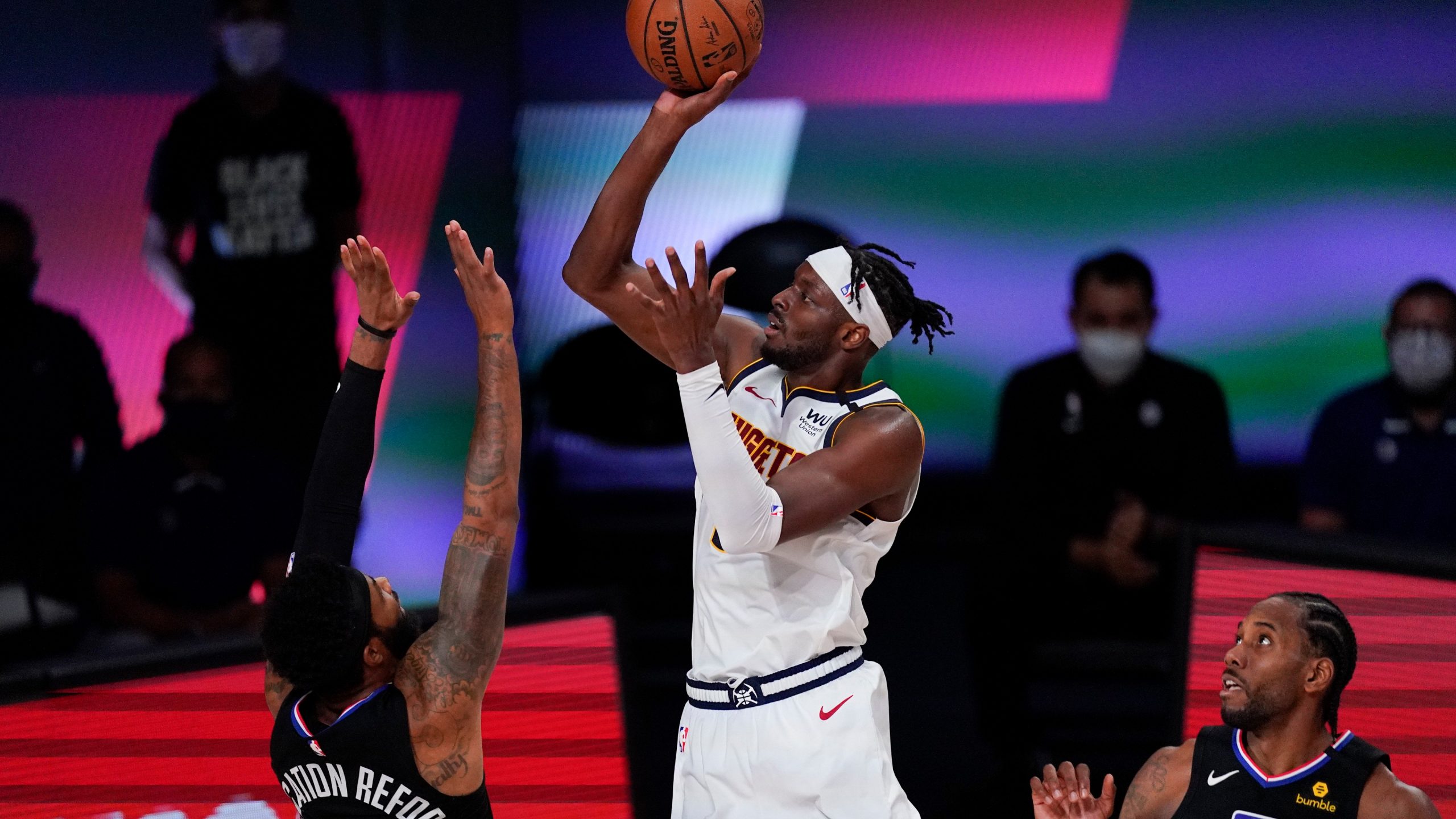 Denver Nuggets' Jerami Grant, center, drives to the basket between Los Angeles Clippers' Marcus Morris Sr., left, and Kawhi Leonard (2) during the second half of an NBA conference semifinal playoff basketball game. (Mark J. Terrill/AP)