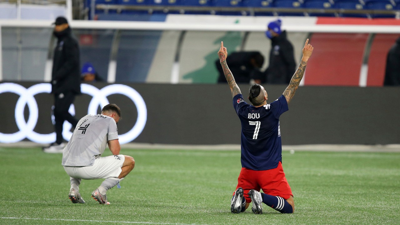 New England Revolution forward Gustavo Bou (7) celebrates as the final whistle blows, next to Montreal Impact defender Rudy Camacho in an MLS soccer match, Friday, Nov. 20, 2020, in Foxborough, Mass. (Steve Milne / AP)