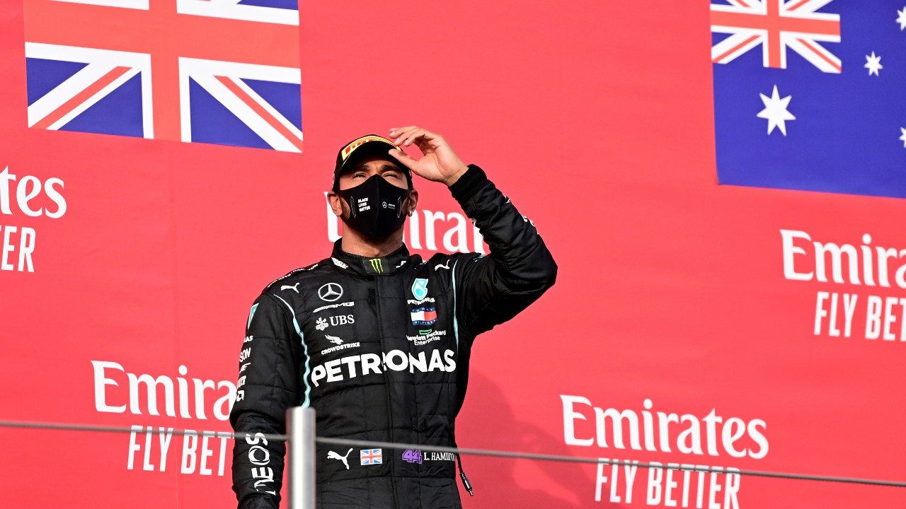 Mercedes driver Lewis Hamilton of Britain celebrates on the podium after winning the Emilia Romagna Formula One Grand Prix. (Miguel Medina, Pool via AP)