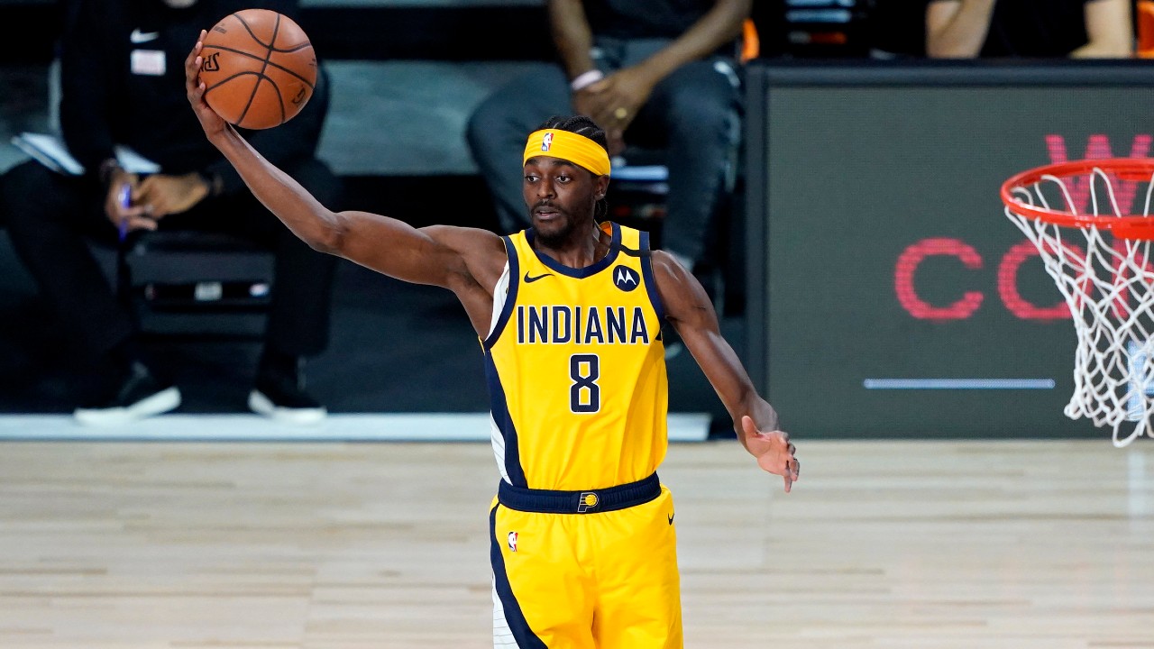 Indiana Pacers' Justin Holiday (8) rebounds against the Miami Heat during the first half of an NBA basketball game. (Ashley Landis, Pool, AP)