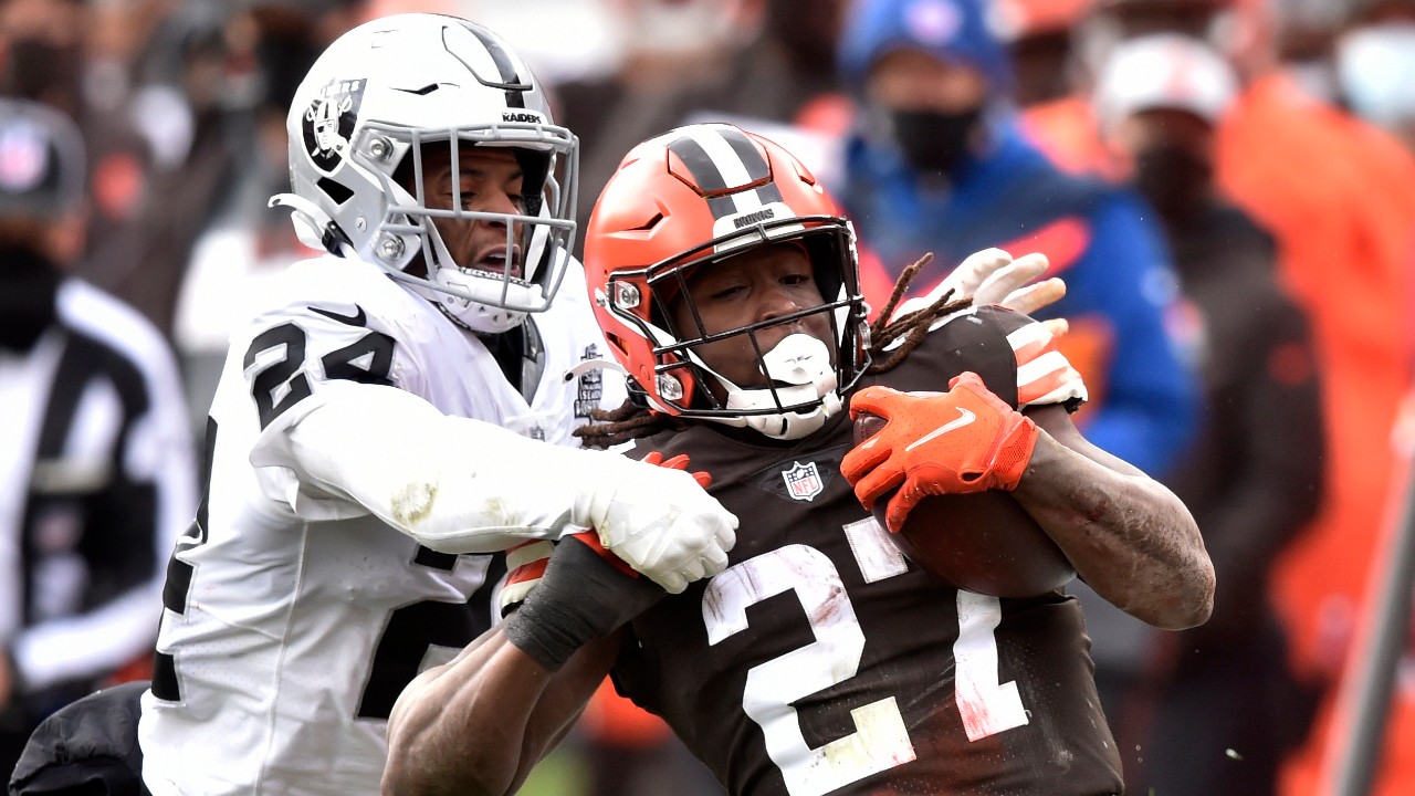 Cleveland Browns running back Kareem Hunt (27) runs for a first down as Las Vegas Raiders strong safety Johnathan Abram (24) tries to tackle him during the first half of an NFL football game, Sunday, Nov. 1, 2020, in Cleveland. (David Richard / AP)
