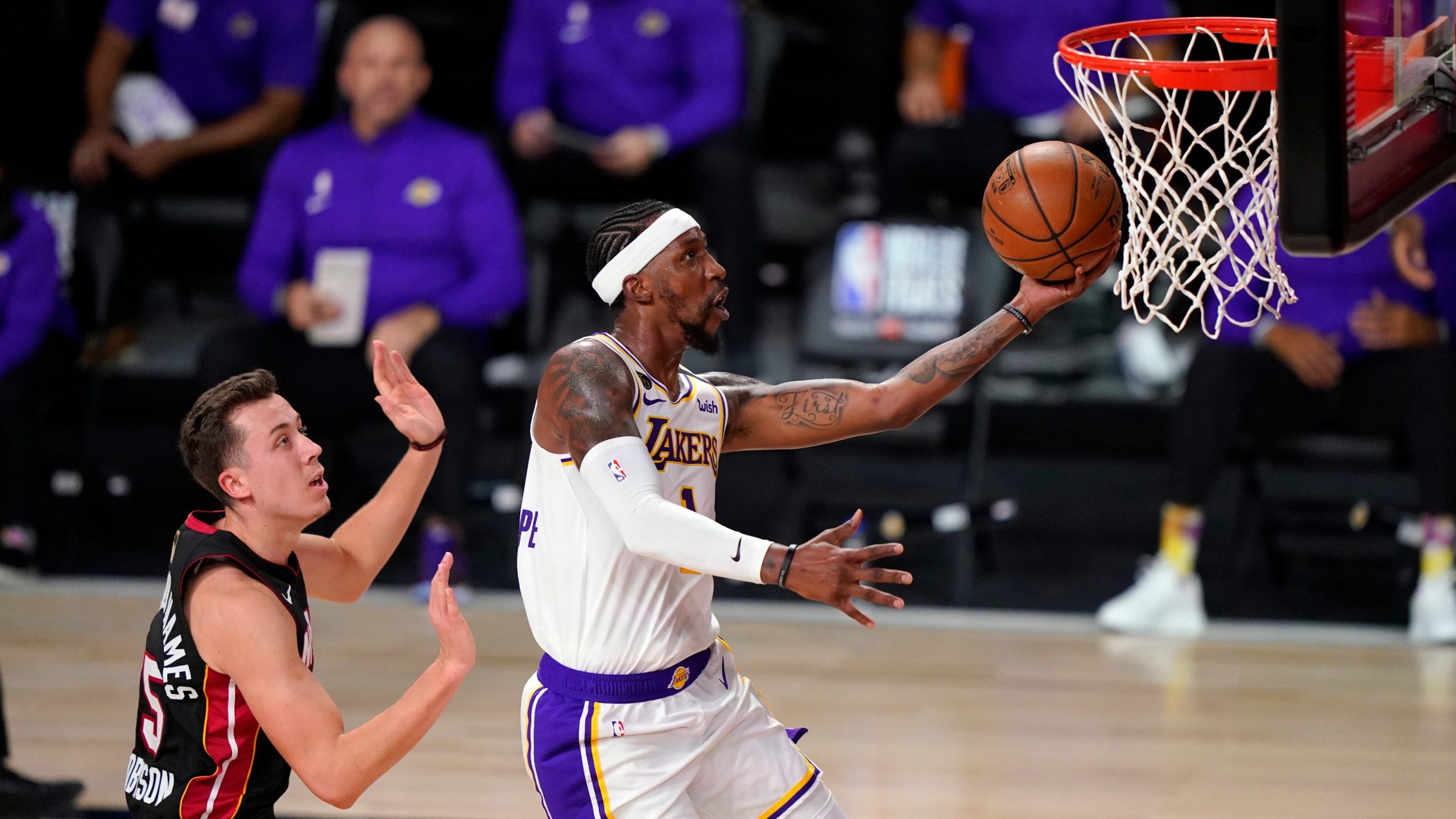 Los Angeles Lakers' Kentavious Caldwell-Pope (1) goes up for a basket against Miami Heat's Duncan Robinson (55) during the first half in Game 6 of basketball's NBA Finals. (Mark J. Terrill/AP)