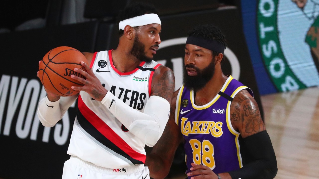 Portland Trail Blazers forward Carmelo Anthony, left, controls the ball against Los Angeles Lakers forward Markieff Morris (88) in the first half of Game 3 of an NBA basketball first-round playoff series. (Kim Klement/Pool Photo via AP)