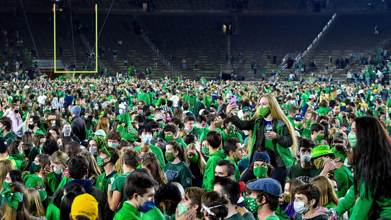 Fans storm the field after Notre Dame defeated the Clemson 47-40 in two overtimes in an NCAA college football game Saturday, Nov. 7, 2020, in South Bend, Ind. (Matt Cashore/Pool Photo via AP)