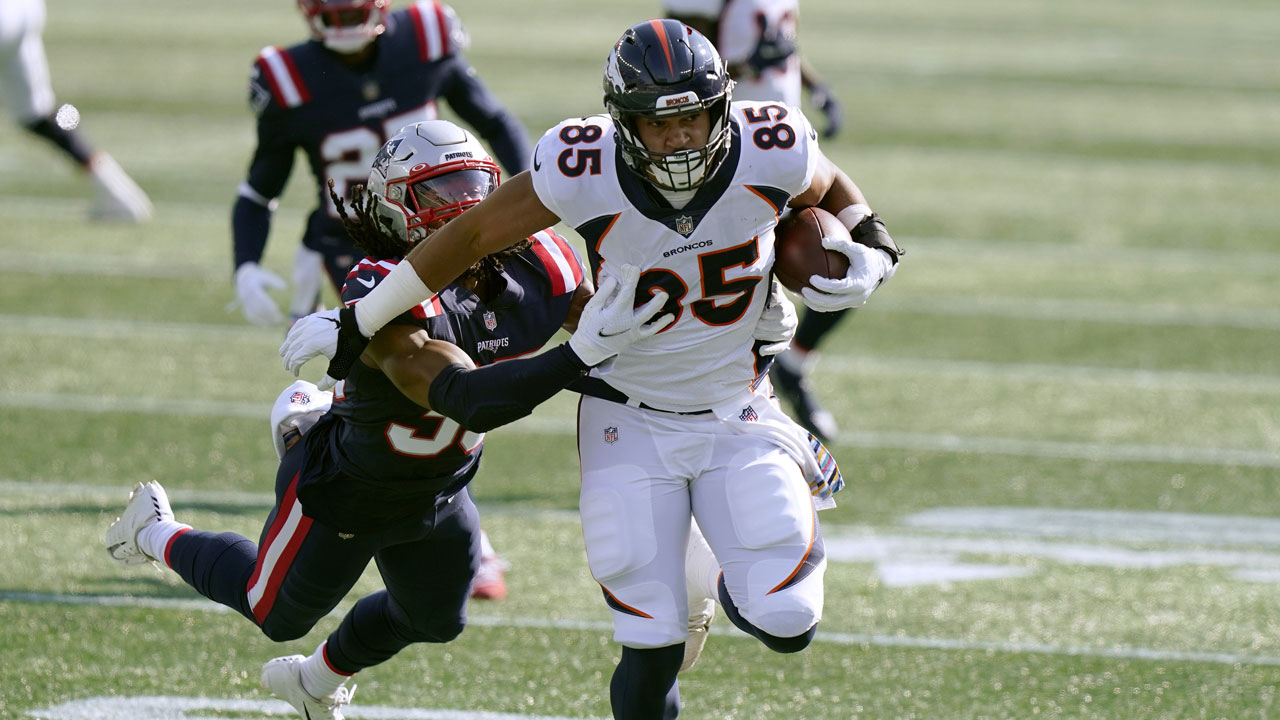 Denver Broncos tight end Albert Okwuegbunam (85) tries to run away from New England Patriots defensive back Kyle Dugger. (Steven Senne/AP)