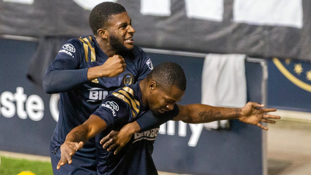 Philadelphia Union's Mark McKenzie, top, leaps upon teammate Cory Burke after he scored the go-ahead and eventual game-winning goal against the Chicago Fire during the second half of an MLS soccer match, Wednesday, Oct. 28, 2020, at Subaru Stadium in Chester, Pa. (Charles Fox/The Philadelphia Inquirer via AP)