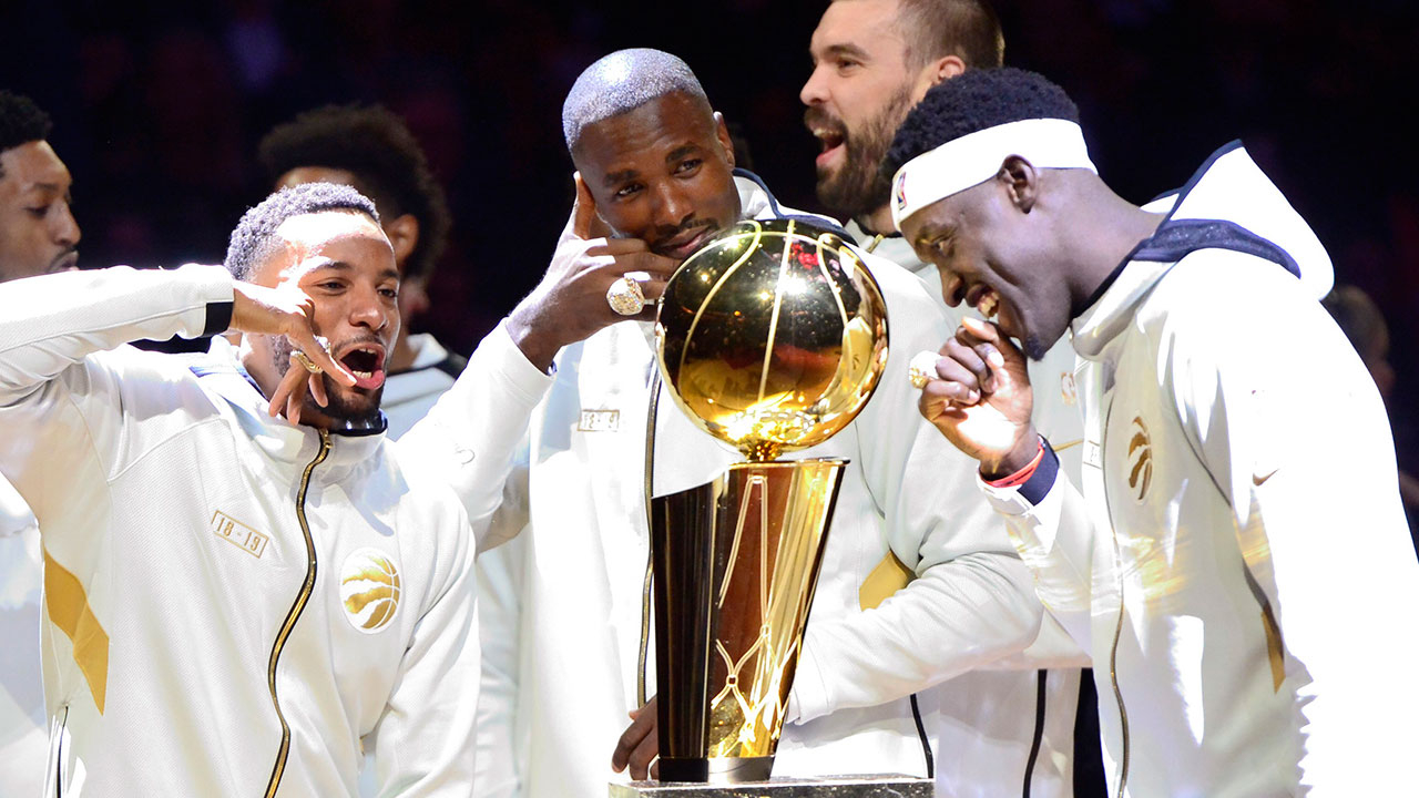 Toronto Raptors' Norm Powell, Serge Ibaka, Marc Gasol and Pascal Siakam stand with their rings behind the Larry O'Brien Trophy. (Frank Gunn/CP)