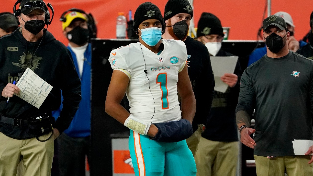 Miami Dolphins quarterback Tua Tagovailoa (1) watches the final minutes from the sidelines during the second half of a game against the Denver Broncos. (Jack Dempsey/AP)