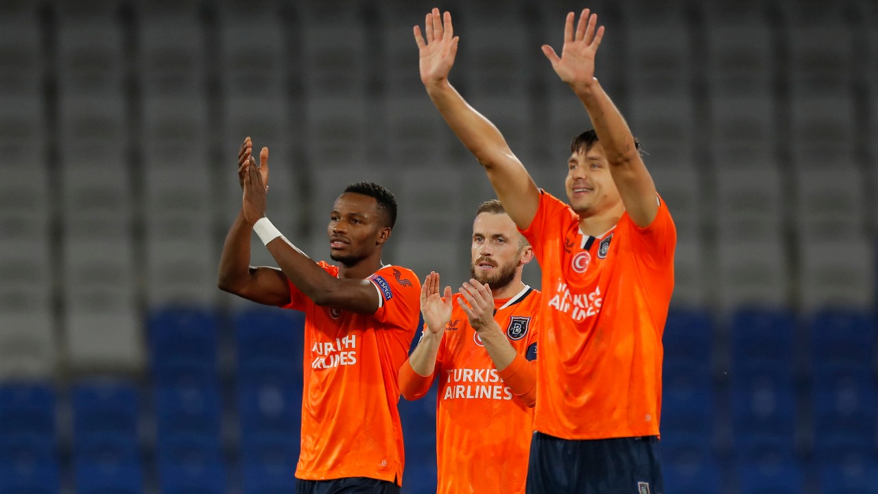 Basaksehir's Boli Bolingoli-Mbombo, left, Basaksehir's Edin Visca, center, and Basaksehir's Alexandru Epureanu applaud fans at the end of the Champions League group H soccer match between Istanbul Basaksehir and Manchester United. (AP Photo)