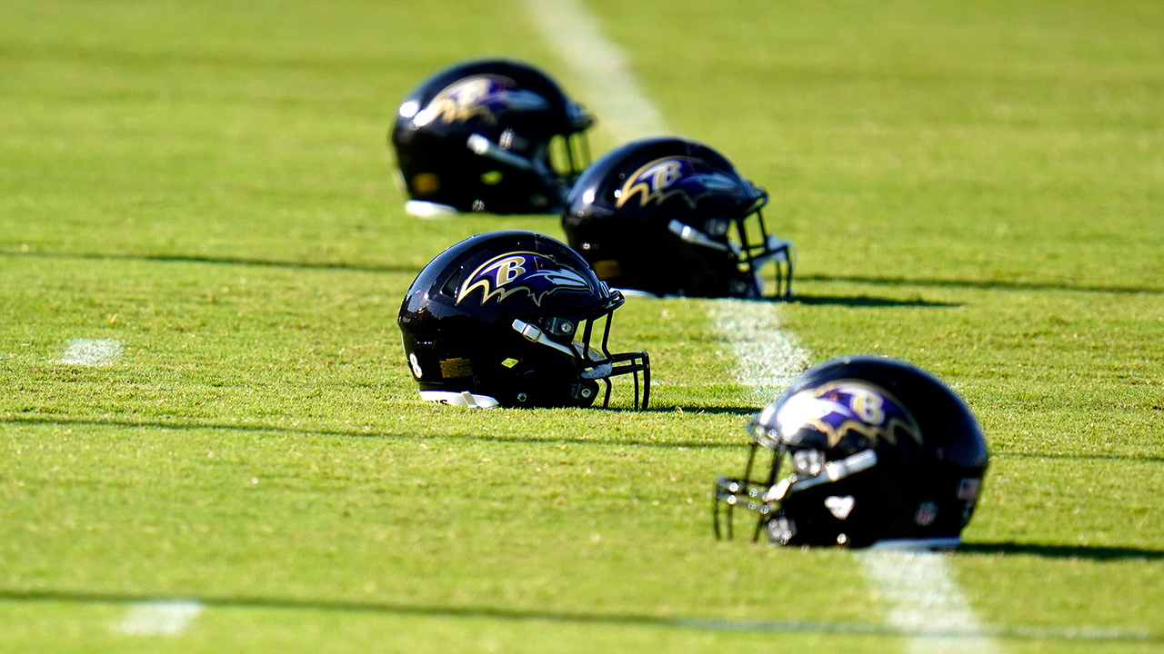 Baltimore Ravens helmets are seen on the field as players warm up during an NFL football camp practice, Tuesday, Aug. 18, 2020, in Owings Mills, Md. (Julio Cortez/AP)