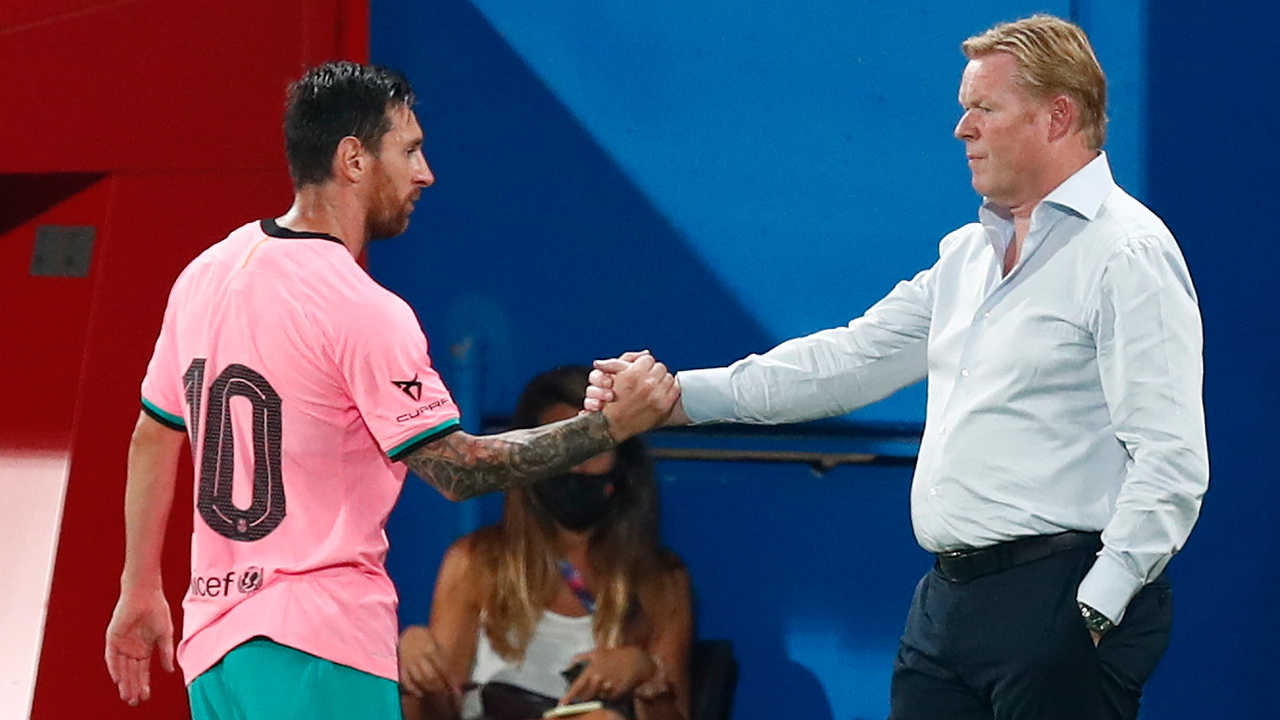 Barcelona's Lionel Messi, left, shakes hands as he is substituted with Barcelona's coach Ronald Koeman as he is substituted during a pre-season friendly match between Barcelona and Girona at the Johan Cruyff Stadium in Barcelona, Spain, Wednesday, Sept. 16, 2020. (Joan Monfort/AP)