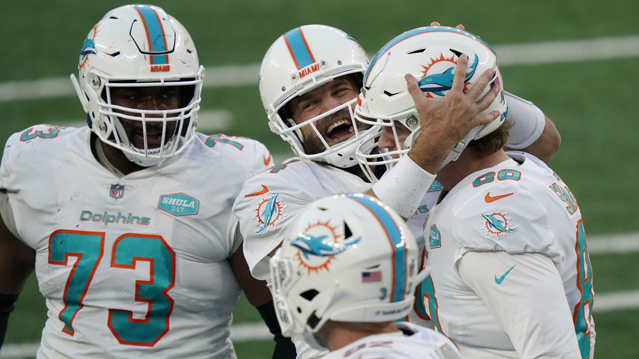Miami Dolphins quarterback Ryan Fitzpatrick, center, celebrates a touchdown with Adam Shaheen, right, during the second half of an NFL football game against the New York Jets. (Corey Sipkin/AP)