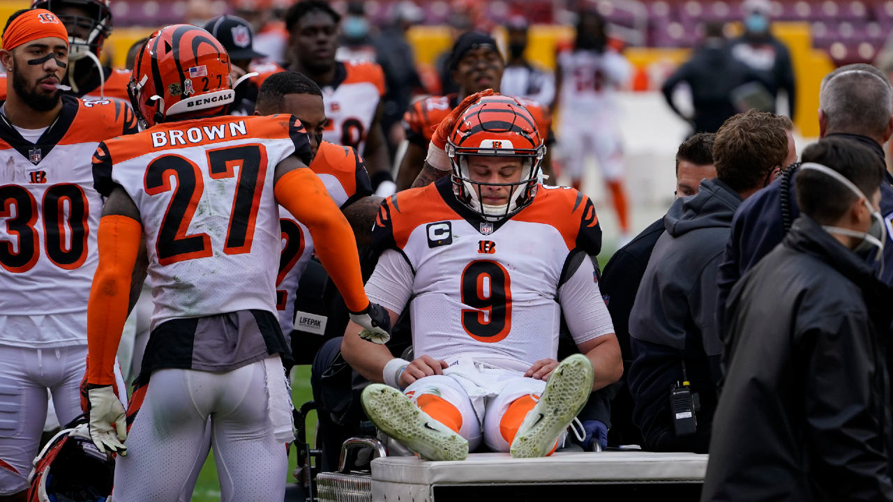 Cincinnati Bengals quarterback Joe Burrow (9) is consoled by teammates as he is carted off the field during the second half of an NFL football game against the Washington Football Team, Sunday, Nov. 22, 2020, in Landover. Burrow was carted off the field with a left knee injury. (Susan Walsh/AP)