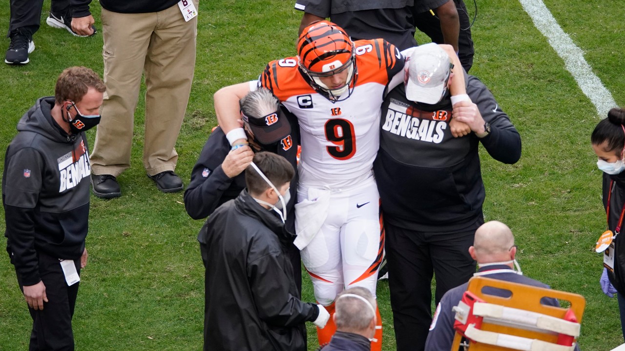 Cincinnati Bengals quarterback Joe Burrow (9) is helped off the field. (AP Photo/Al Drago)