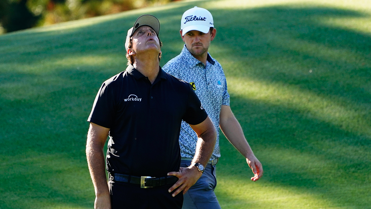 Bernd Wiesberger, of Austria, walks past as Phil Mickelson reacts after a missed putt on the eighth hole during the second round of the Masters golf tournament Friday, Nov. 13, 2020, in Augusta, Ga. (Matt Slocum/AP)