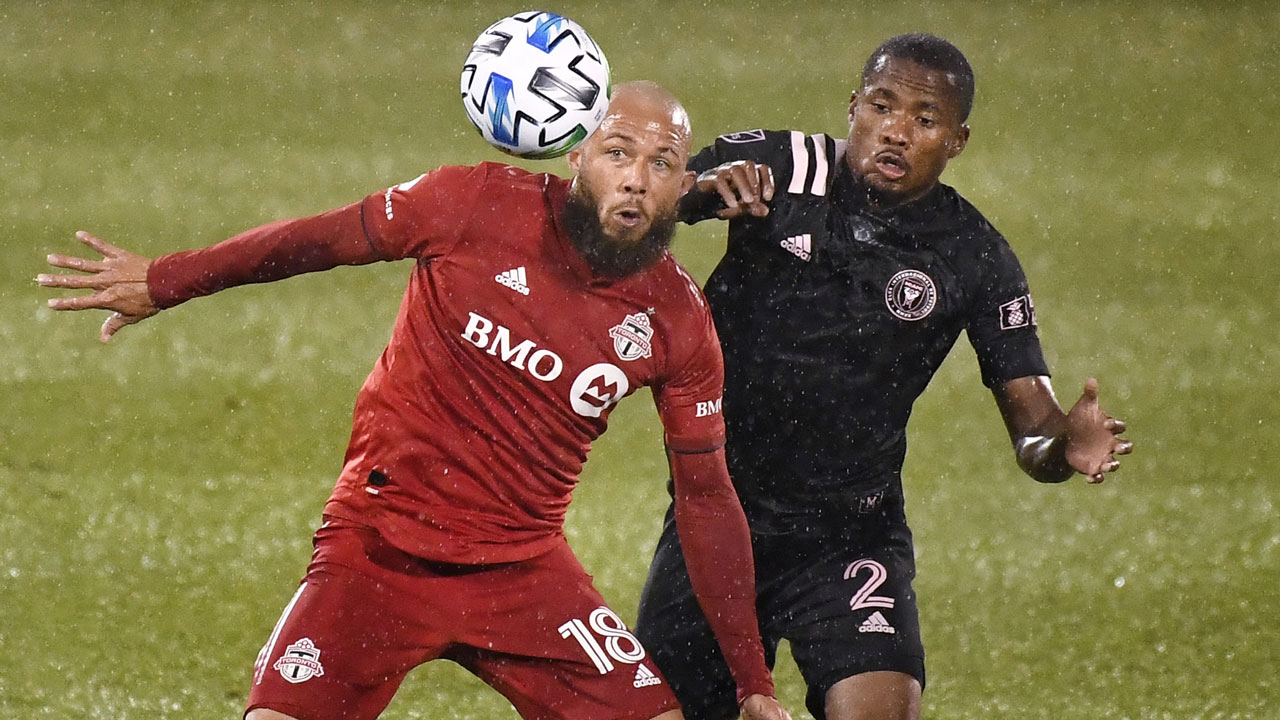 Toronto FC's Nick DeLeon, left, eyes the ball as Inter Miami's Alvas Powell, right, defends during the first half of an MLS match, Sunday. (Jessica Hill/AP)