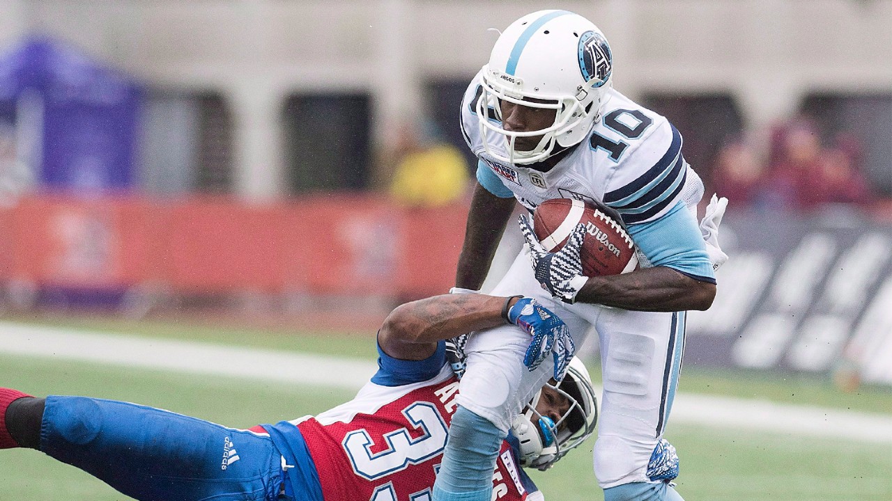 Montreal Alouettes' Greg Reid, left, tackles Toronto Argonauts' Armanti Edwards during second half CFL football action in Montreal, Sunday, Oct. 28, 2018. (Graham Hughes/CP)