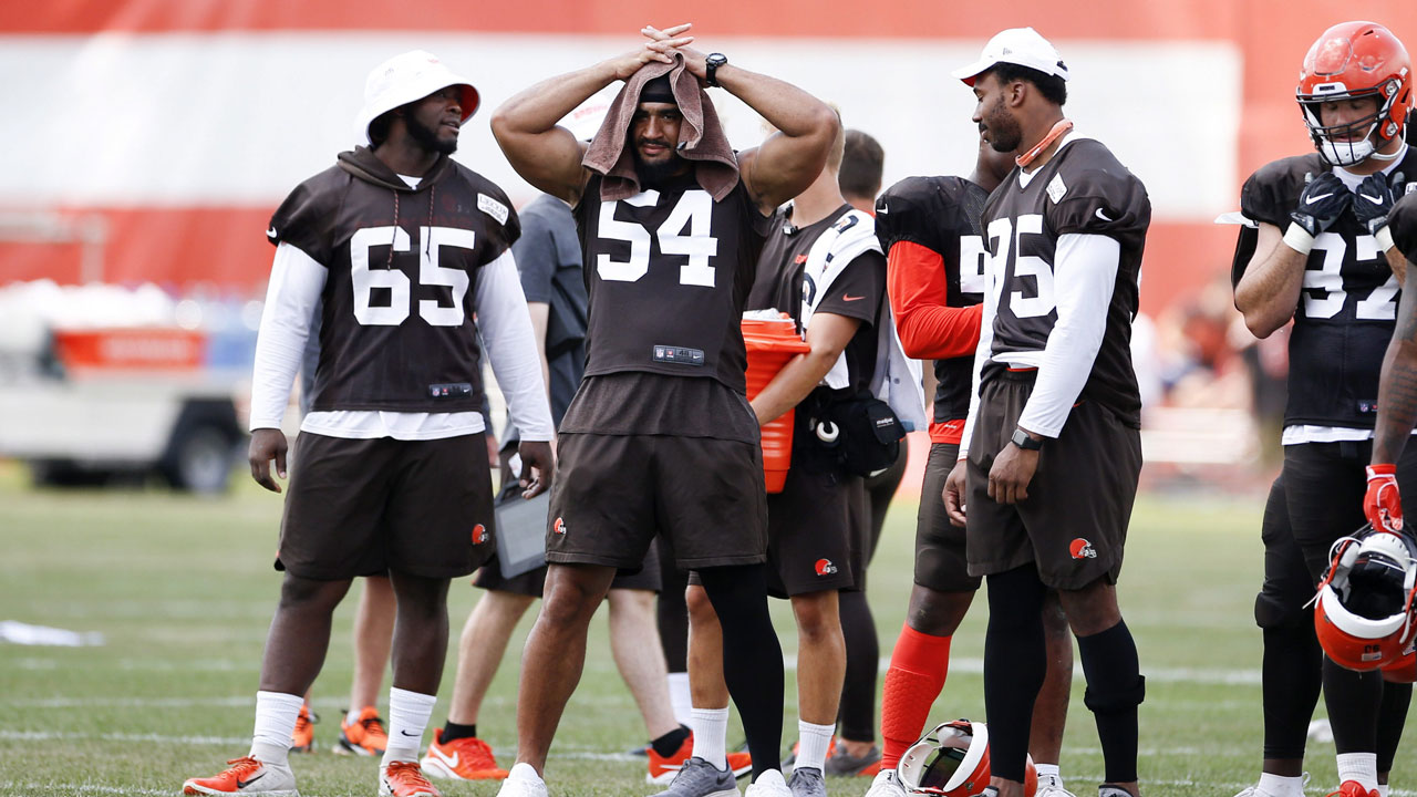 Cleveland Browns defensive tackle Larry Ogunjobi (65), outside linebacker Olivier Vernon (54) and defensive end Myles Garrett (95) watch from the sidelines during practice. (Ron Schwane/AP)