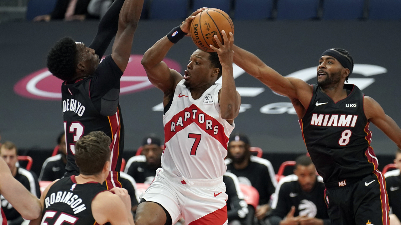 Toronto Raptors guard Kyle Lowry (7) goes to the basket between Miami Heat forward Bam Adebayo (13) and forward Maurice Harkless during the first half of an NBA pre-season basketball game Friday, Dec. 18, 2020. (Chris O'Meara/AP)