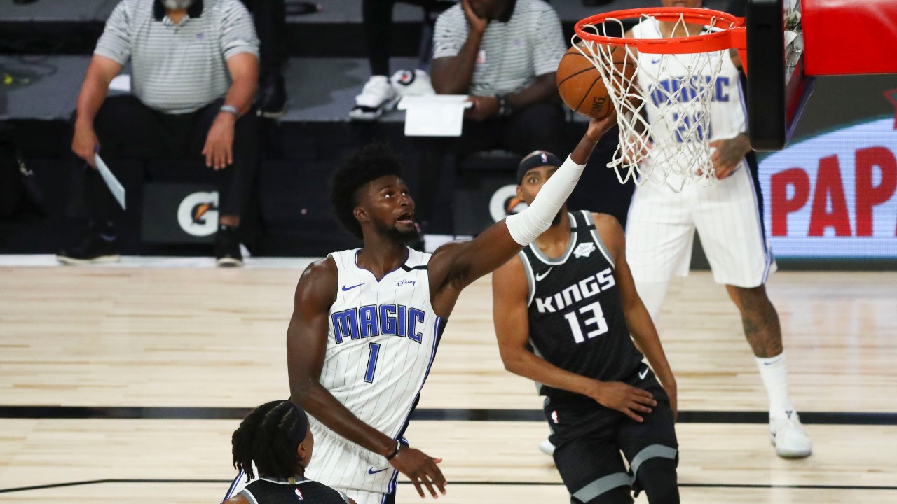 Orlando Magic forward Jonathan Isaac (1) shoots the basketball against Sacramento Kings center Richaun Holmes (22) and guard Corey Brewer (13) in the first half of an NBA basketball game. (Kim Klement/Pool Photo via AP)