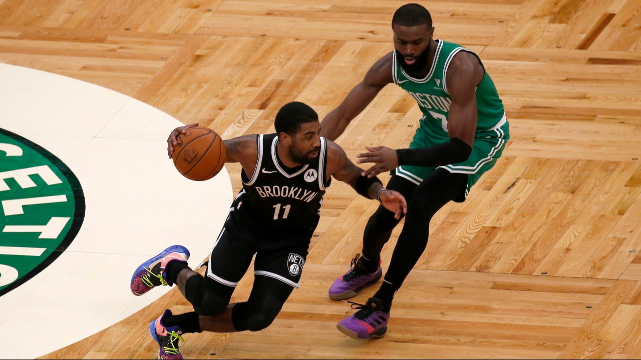 Brooklyn Nets guard Kyrie Irving (11) drives against Boston Celtics guard Jaylen Brown (7) during the first half of an NBA preseason basketball game. (Mary Schwalm/AP)