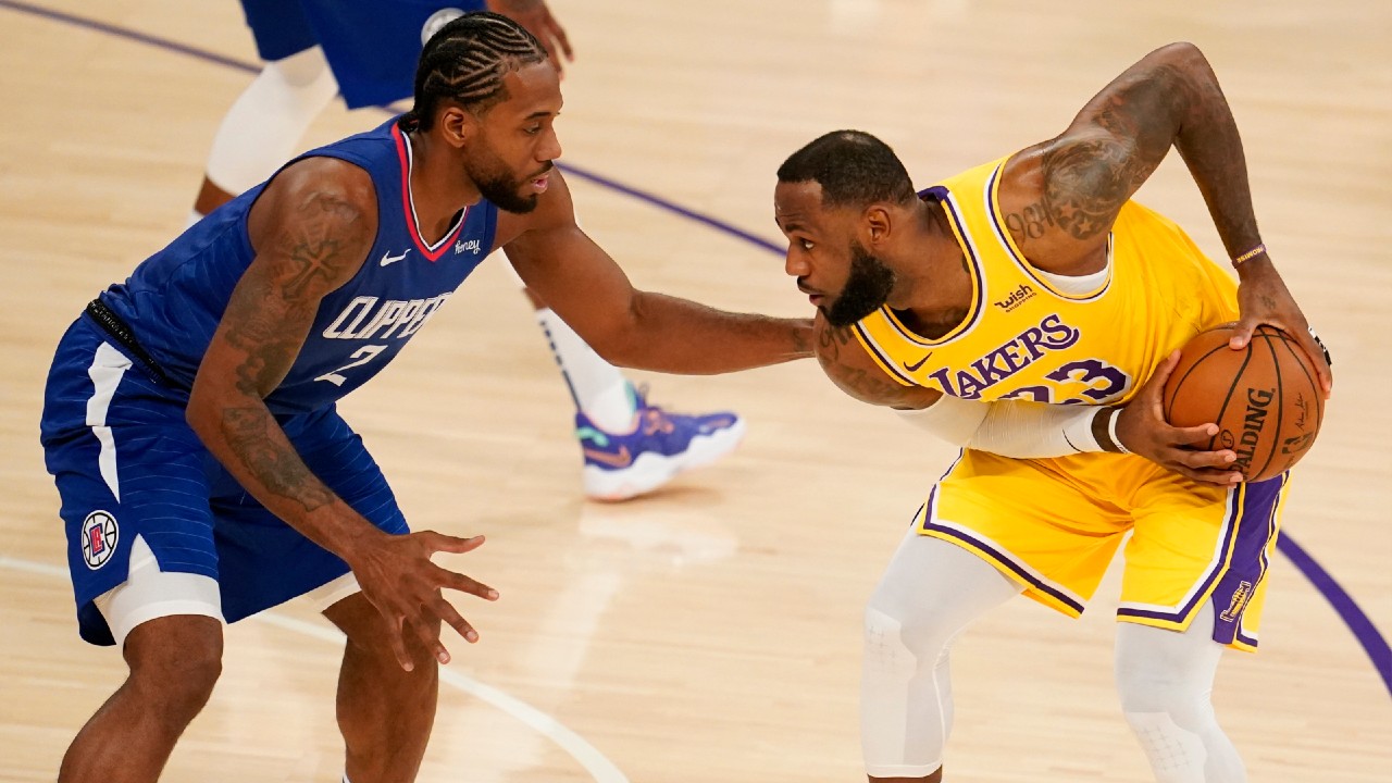 Los Angeles Lakers forward LeBron James, right, is defended by Los Angeles Clippers forward Kawhi Leonard during the first half of an NBA basketball game Tuesday, Dec. 22, 2020, in Los Angeles. (Marcio Jose Sanchez/AP)