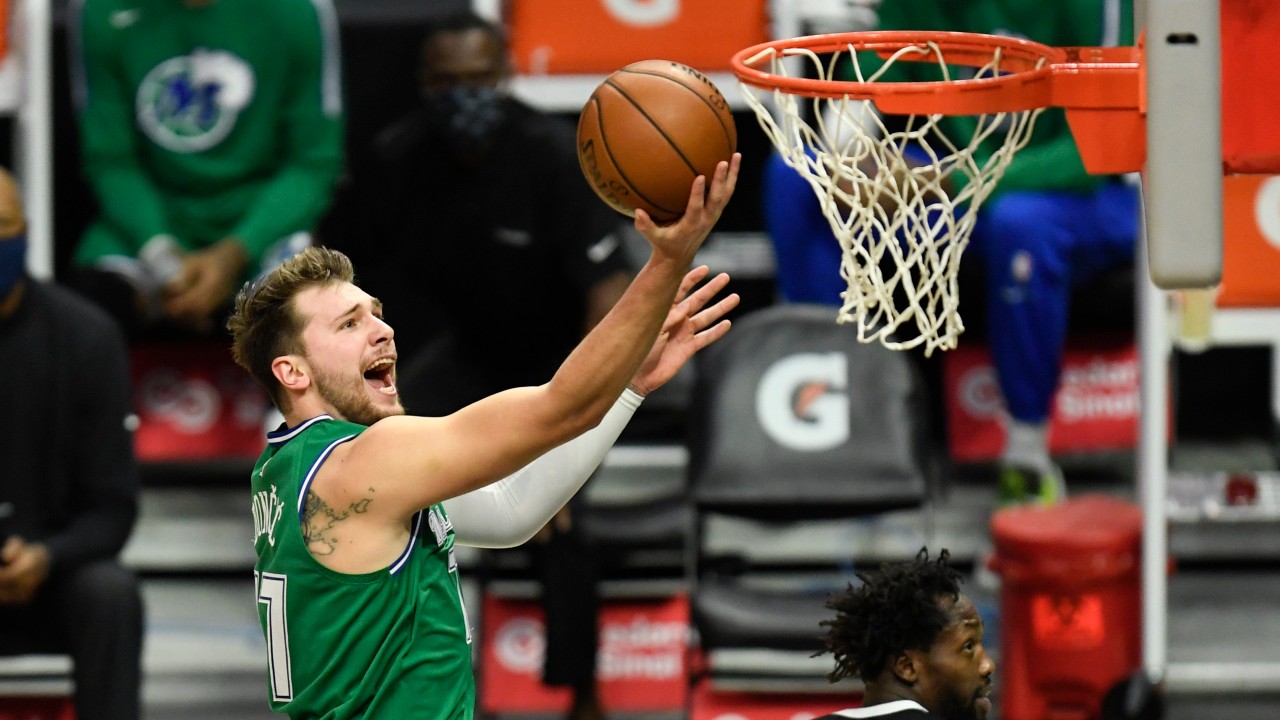 Dallas Mavericks guard Luka Doncic, left, goes up for a basket past Los Angeles Clippers guard Patrick Beverley during the first half of an NBA basketball game. (Kyusung Gong/AP)